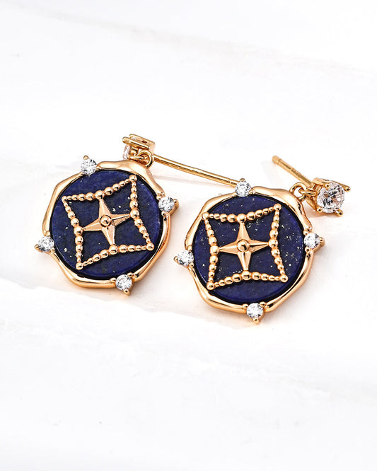 Pair of earrings with gold and blue design on a white background