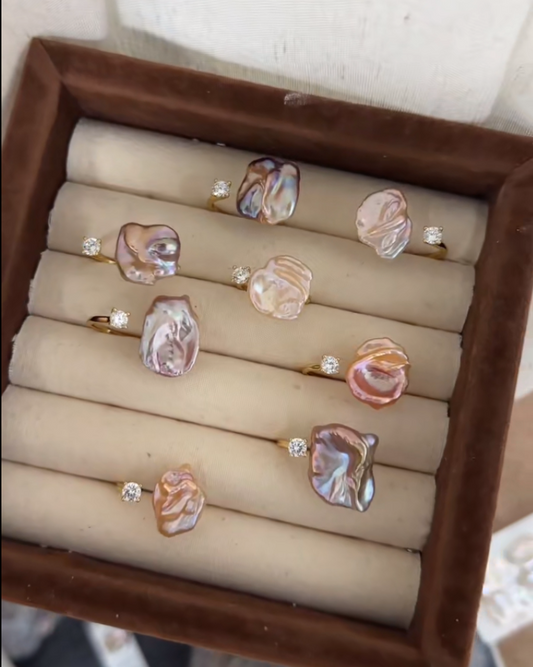 Set of earrings on display in a brown jewelry box