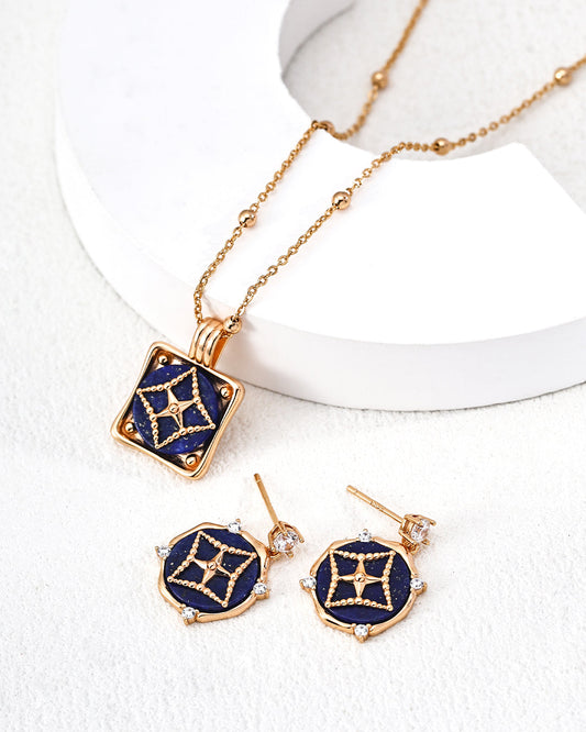 Gold and blue jewelry set including necklace, earrings, and ring on a white background