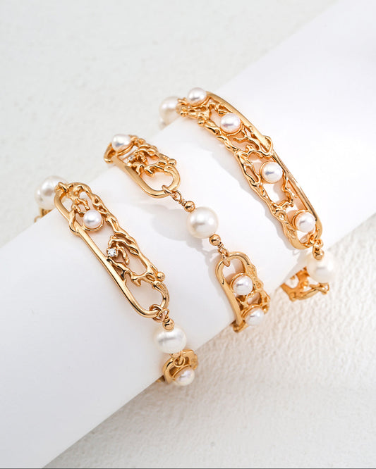 Gold bracelet with pearls on a white background