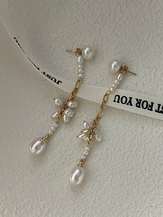 Pearl earrings with gold accents on a white background